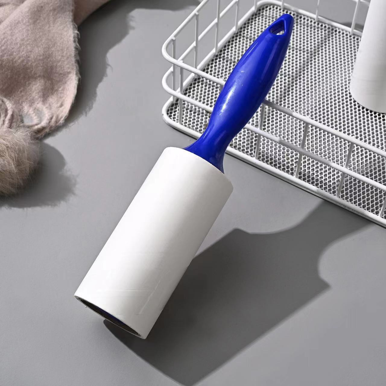 Tearable Lint Remover with blue handle designed to effectively remove lint and pet hair from surfaces.
