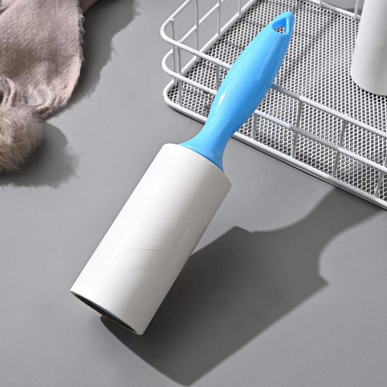 Tearable Lint Remover with blue handle for removing lint and pet hair from various surfaces.