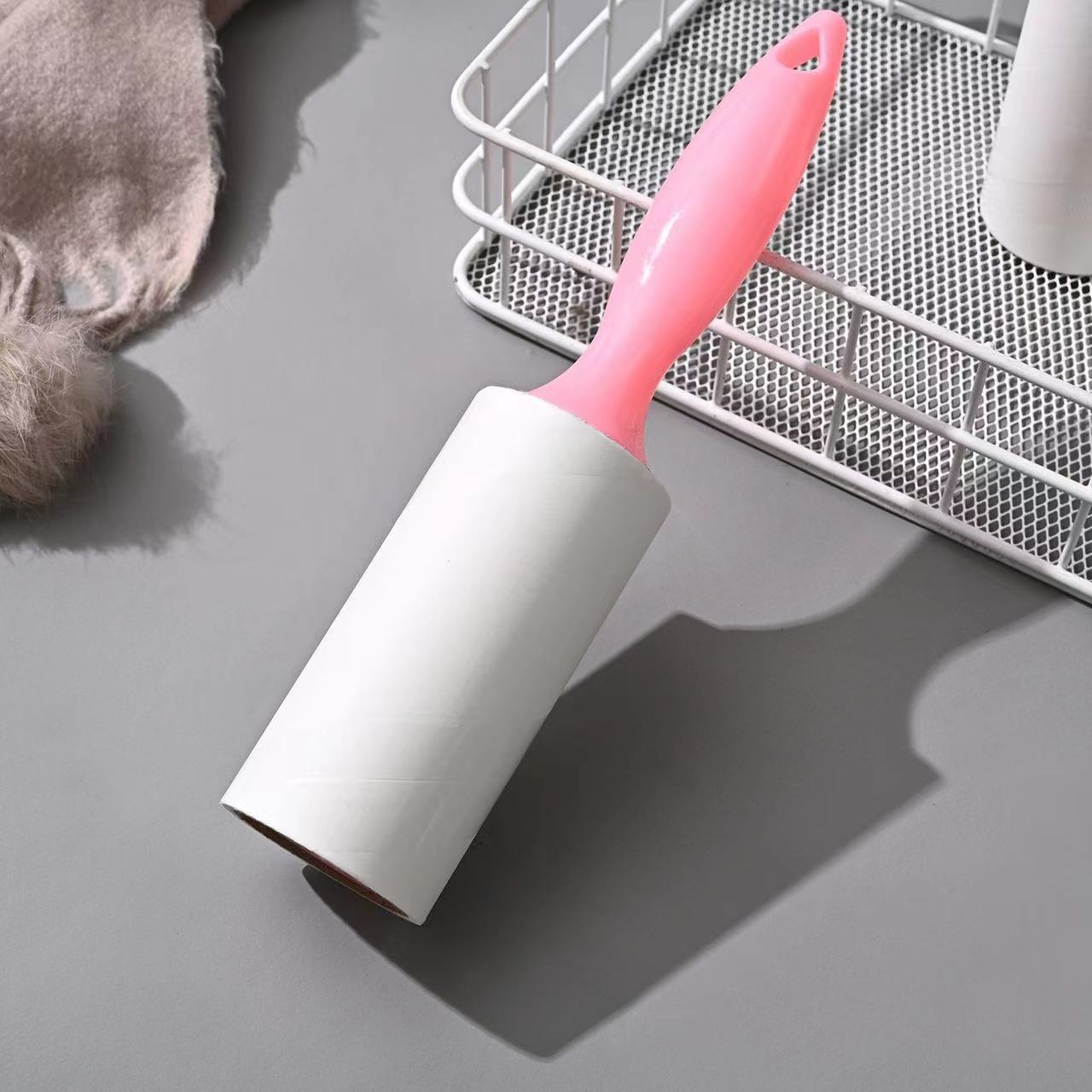 Tearable Lint Remover roller with a pink handle for easy lint and pet hair removal.