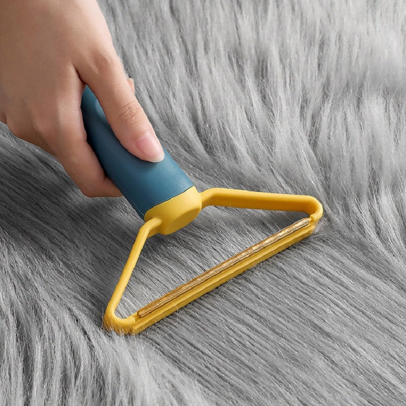 Sofa Clothes Cleaning Lint Brush removing pet hair from soft fabric surface